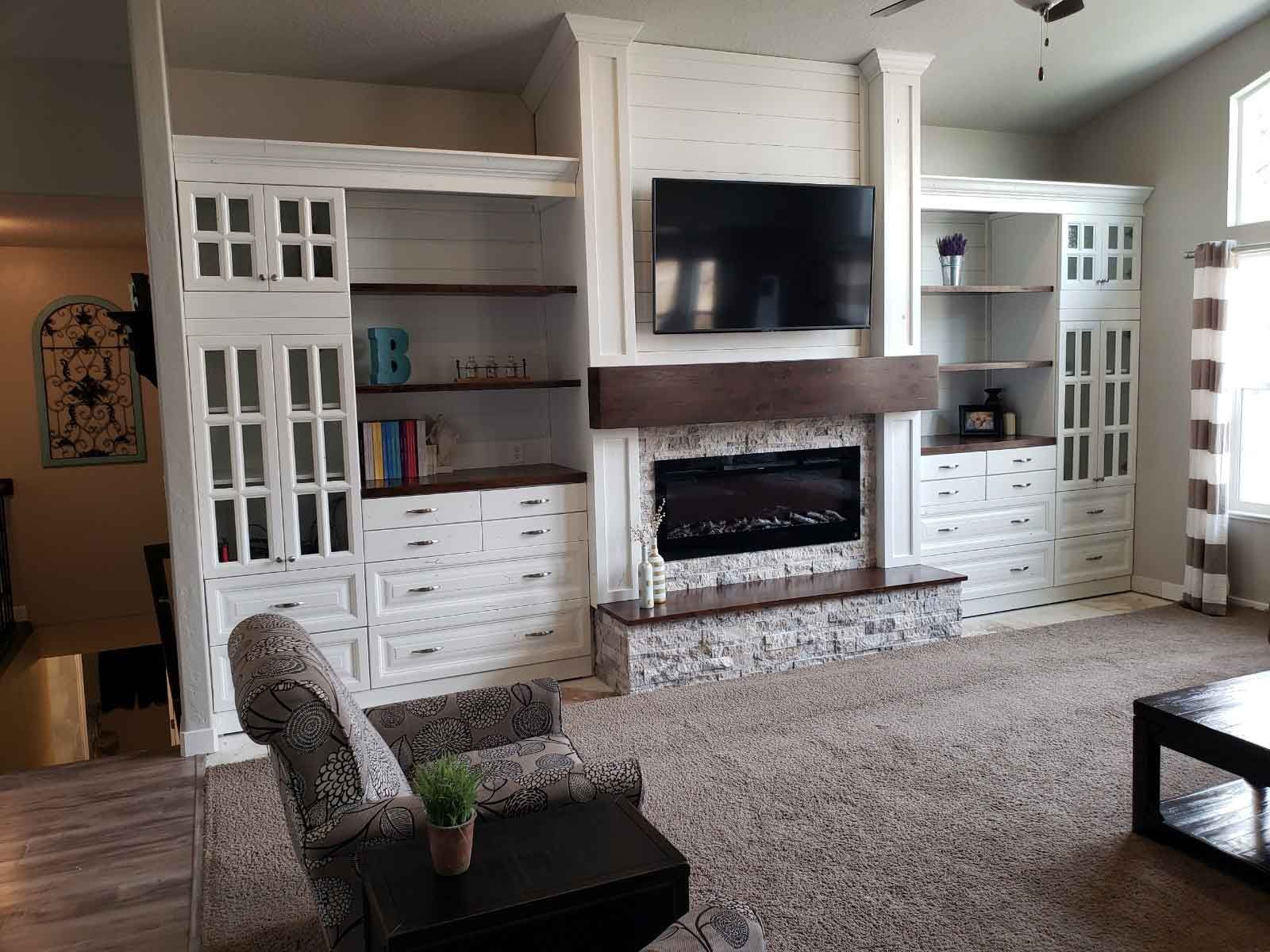 A living room with a fireplace and a flat screen tv.