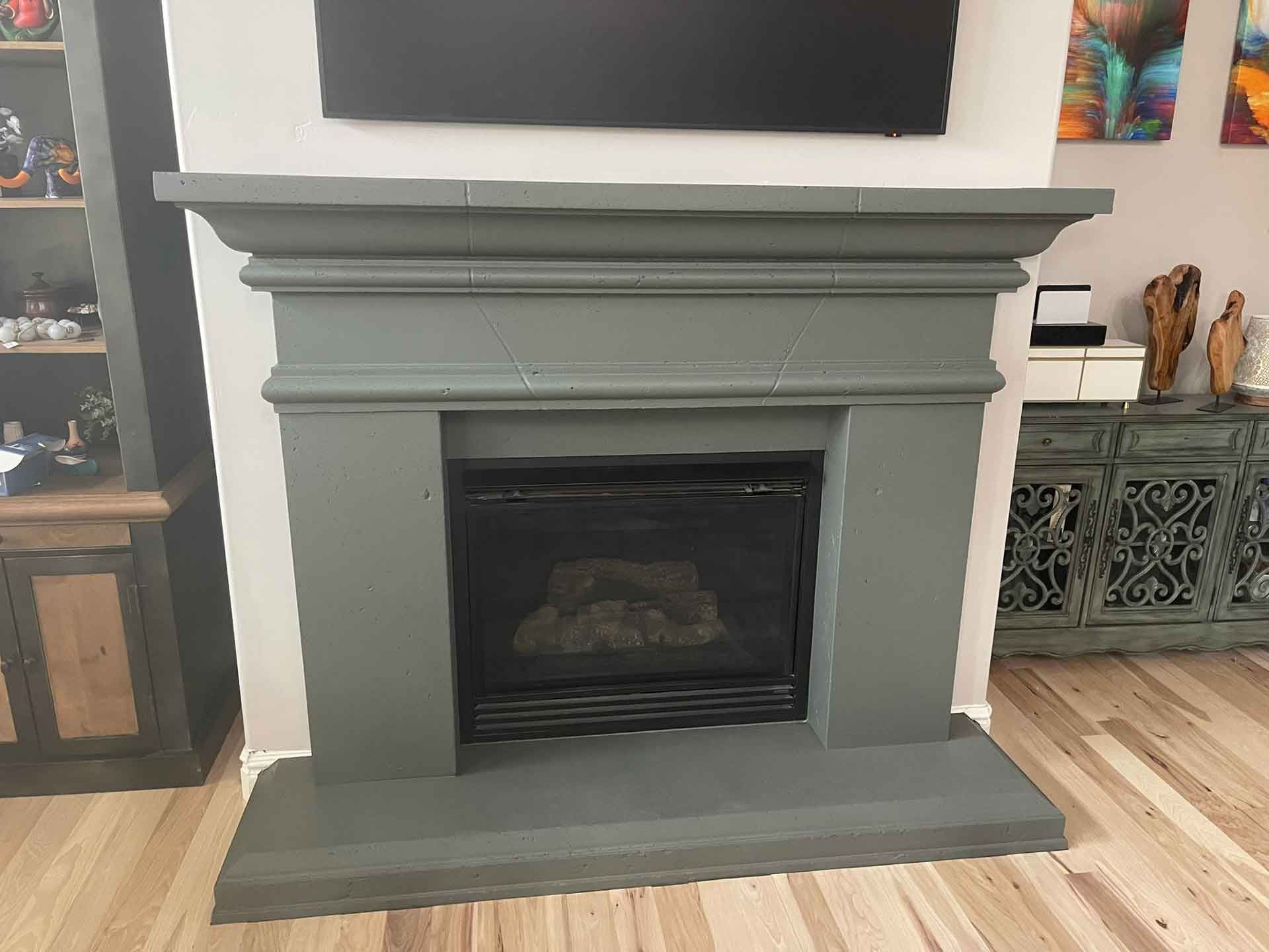 A fireplace in a living room with a flat screen tv above it.