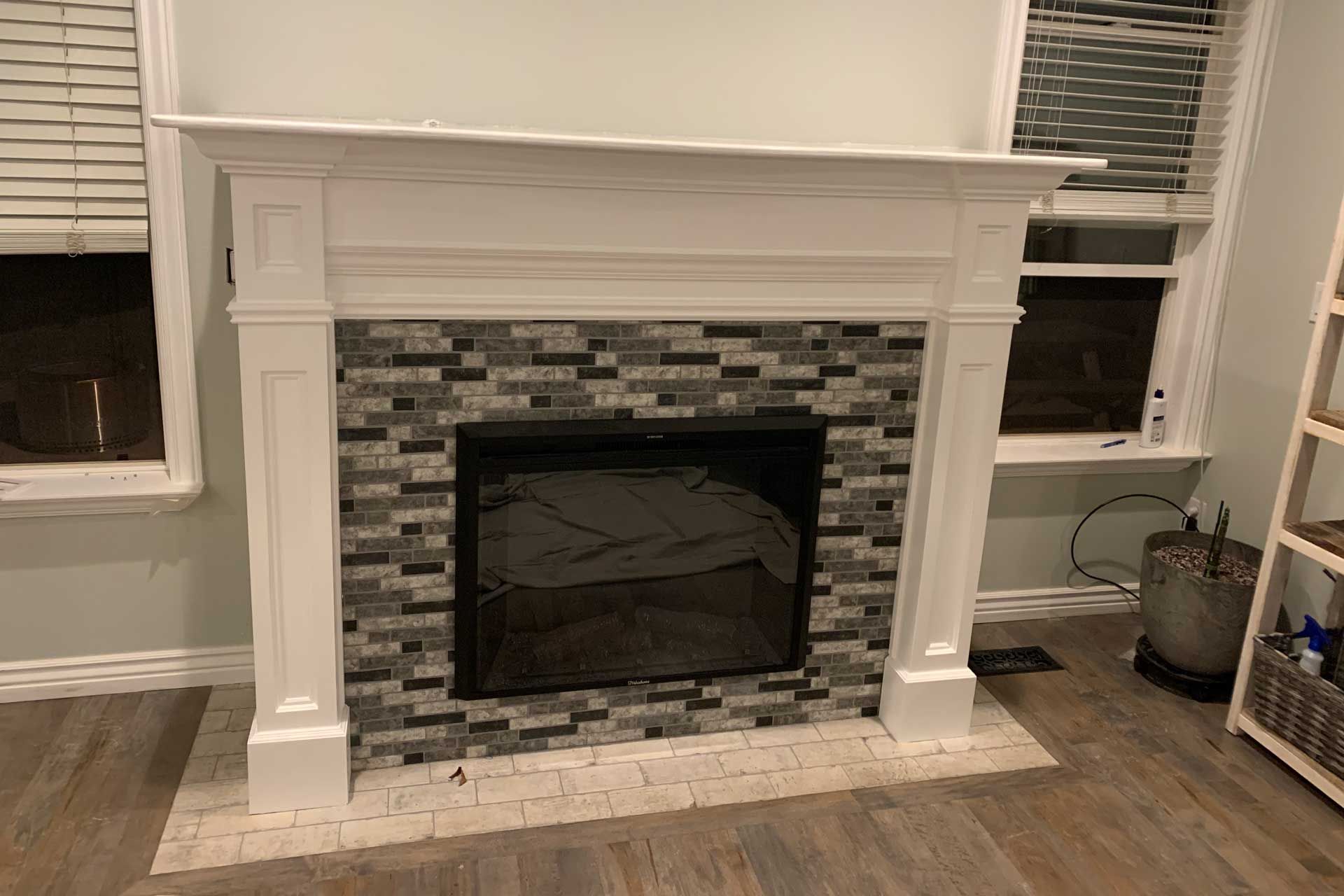 A living room with a fireplace and a window.
