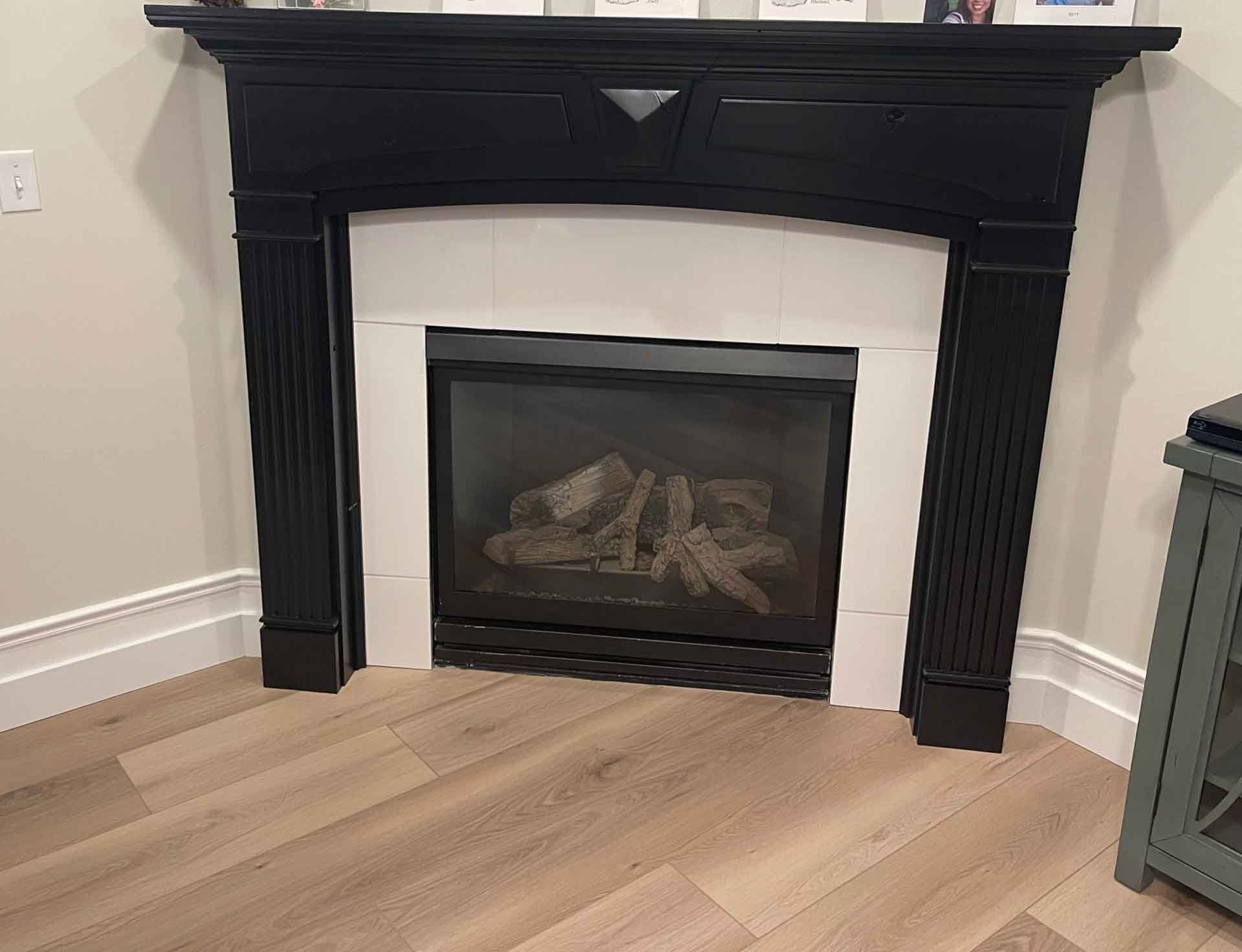 There is a fireplace in the corner of the room.