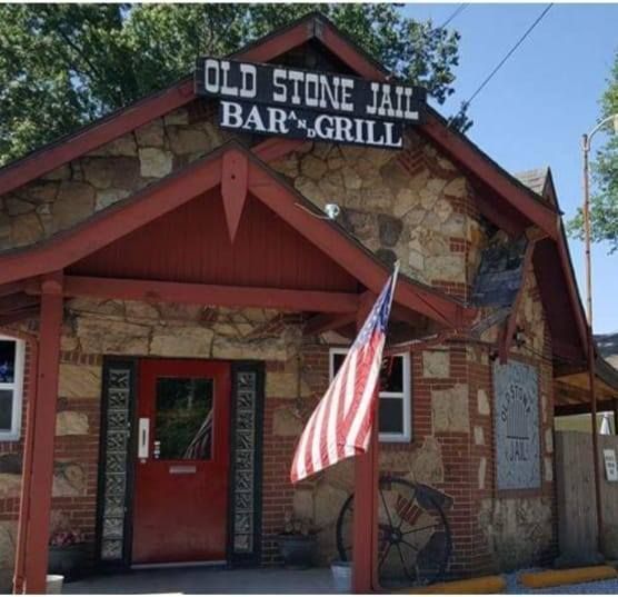 Lynn's Food & Spirits, brick building with red awnings and sign, windows, snow on sidewalk.