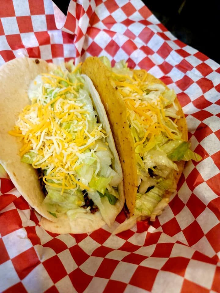 Chocolate martini in a bar, rimmed with sugar, sitting on a blue coaster.