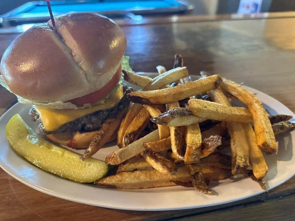 Breakfast plate with fried eggs, bacon, toast, and potato hash.