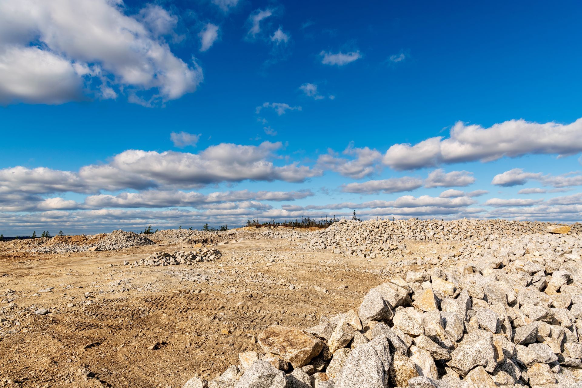 a graded rock quarry with big skies and puffy clouds.  Palmdale, Ca