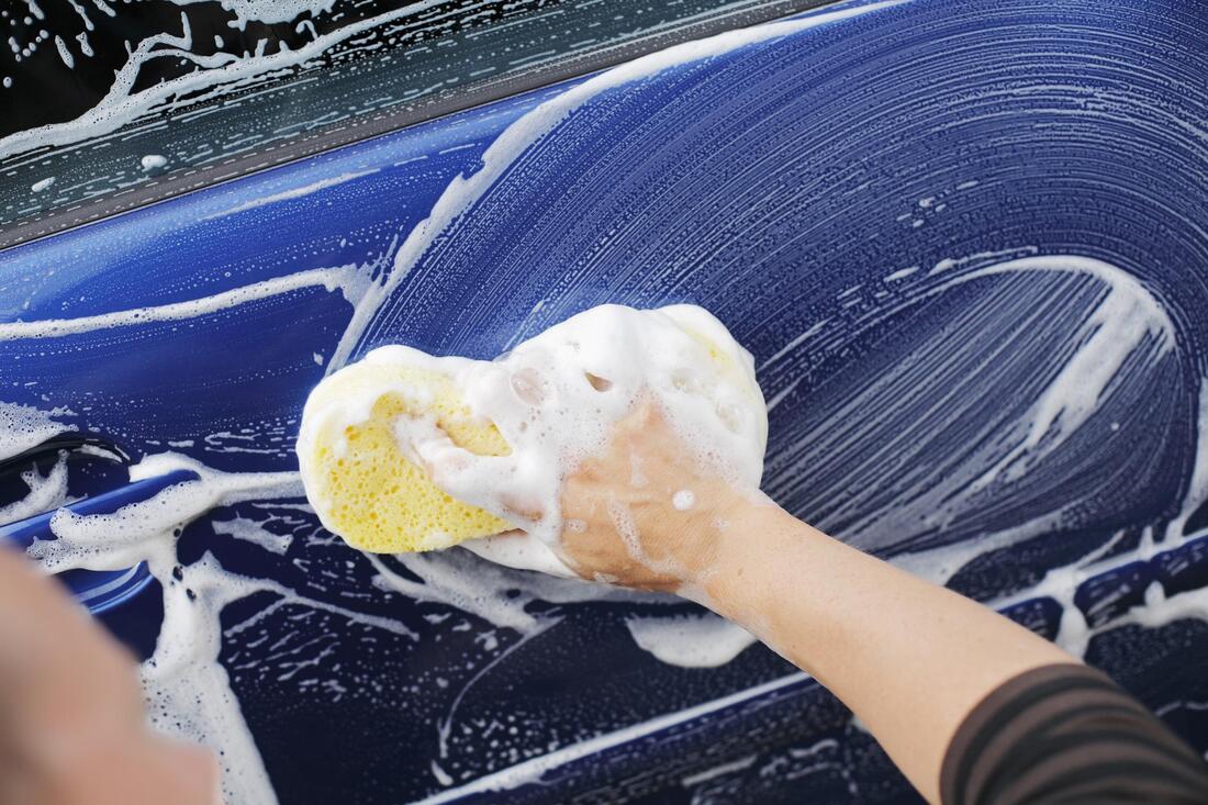 employee hand washing a customers car in phoenix arizona