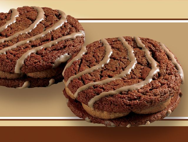 A close up of two chocolate cookies on a table