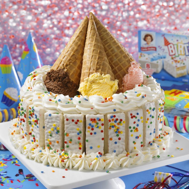 A birthday cake with ice cream cones and sprinkles