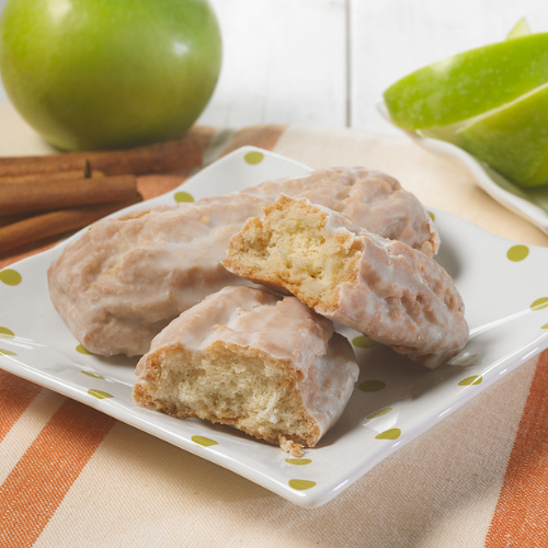 A plate of donuts with a bite taken out of one of them