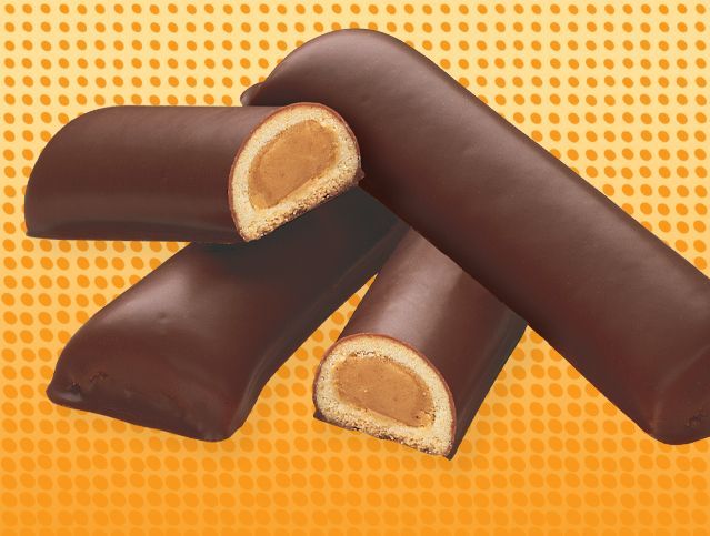 Four chocolate covered cookies are stacked on top of each other