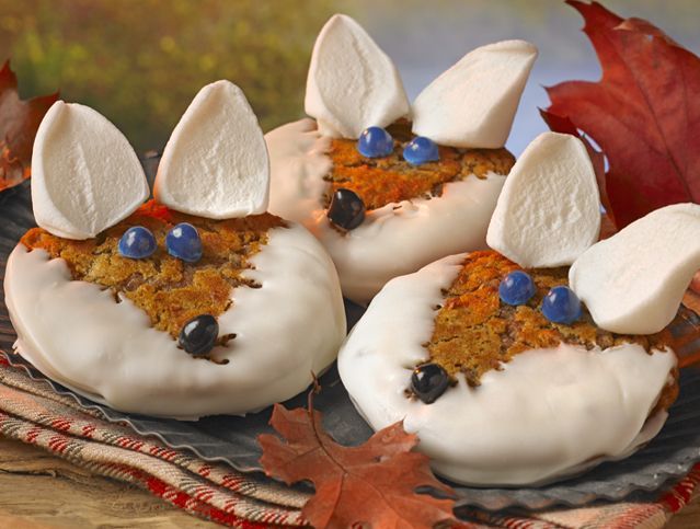 A close up of three cookies that look like rabbits