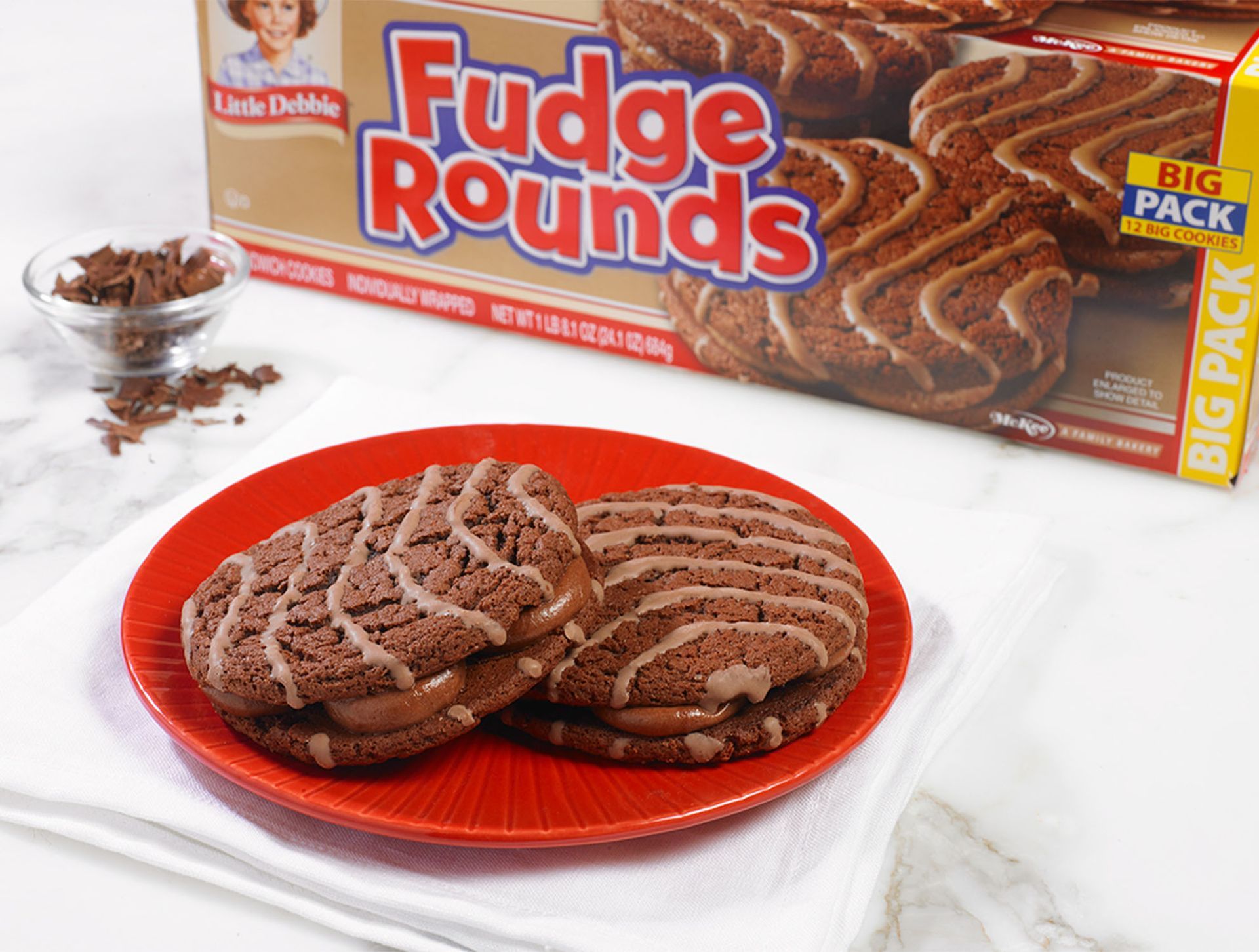 A box of fudge rounds cookies sits next to a plate of cookies