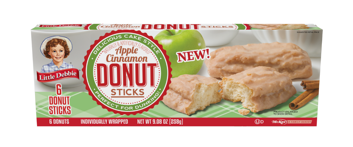 A box of apple cinnamon donut sticks with a green apple in the background.