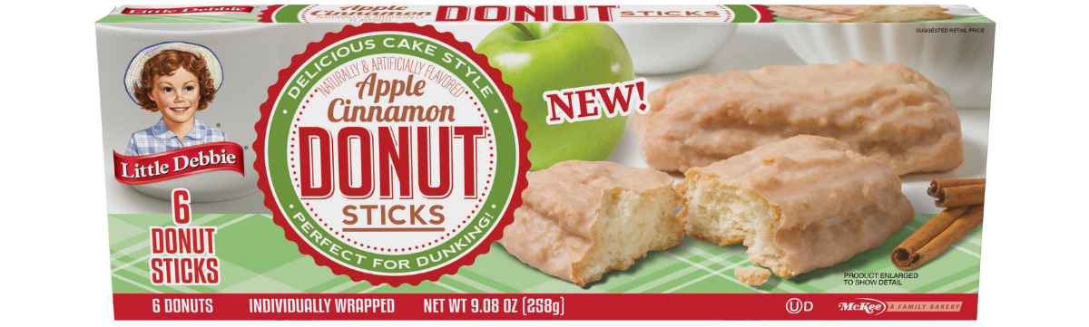 A box of apple cinnamon donut sticks with a green apple in the background.