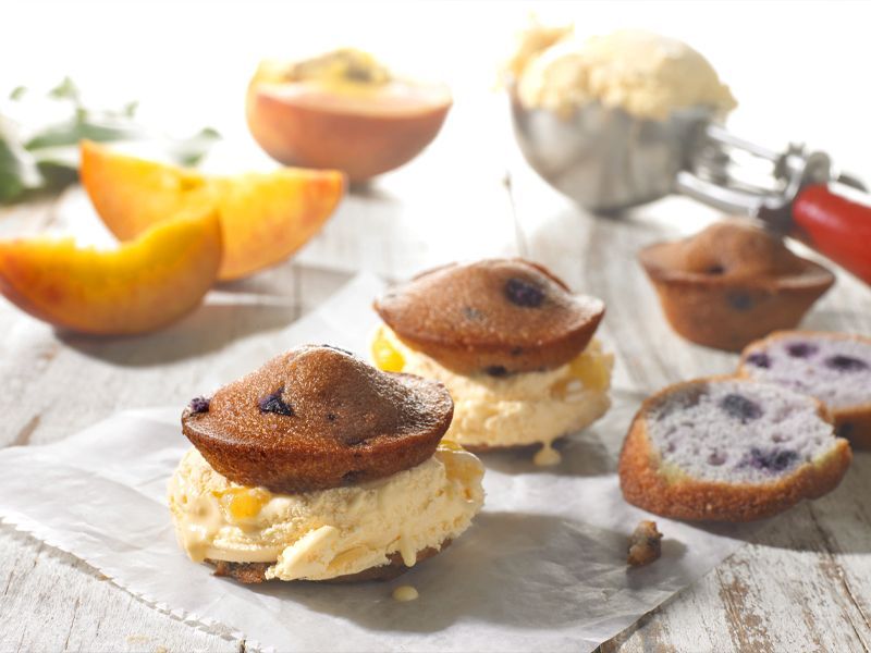 Cupcakes with ice cream on top of them on a table