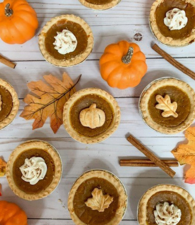 mini pumpkin pies topped with baked leaves and pumpkin shapes