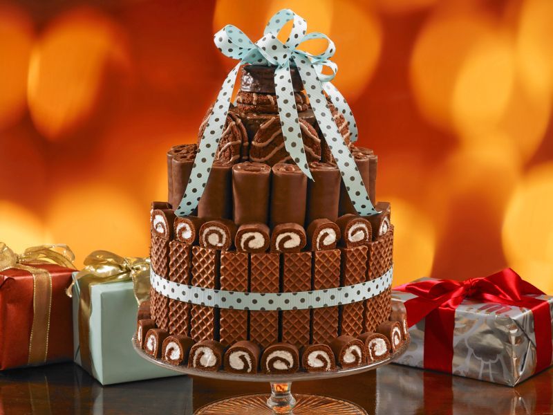 A chocolate cake with gifts in the background