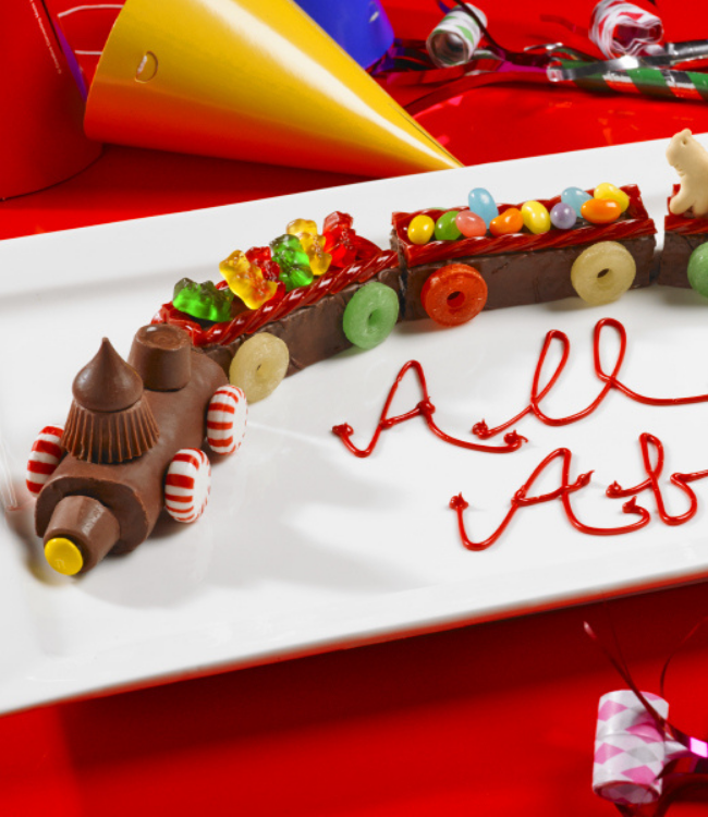 celebration train with swiss rolls and fudge cakes