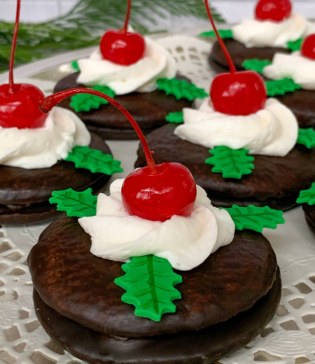 christmas cherry cordials topped with whipped cream and maraschino cherries