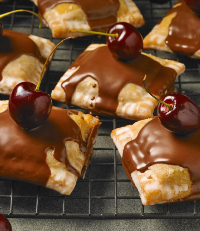 cherry pies topped with chocolate and fresh cherries