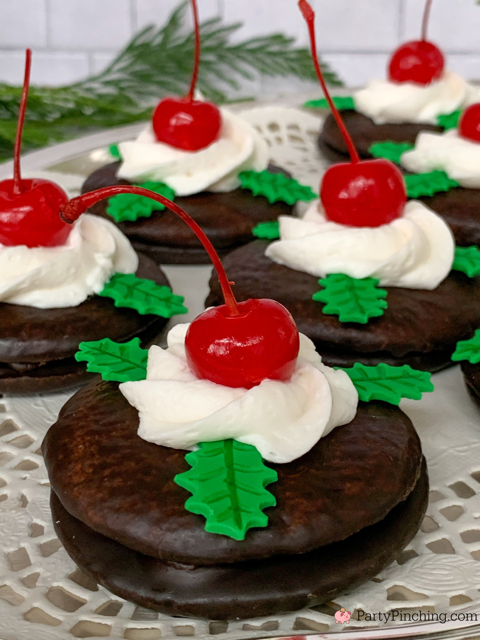 christmas cherry cordials topped with candy holly leaves, whipped topping and maraschino cherries