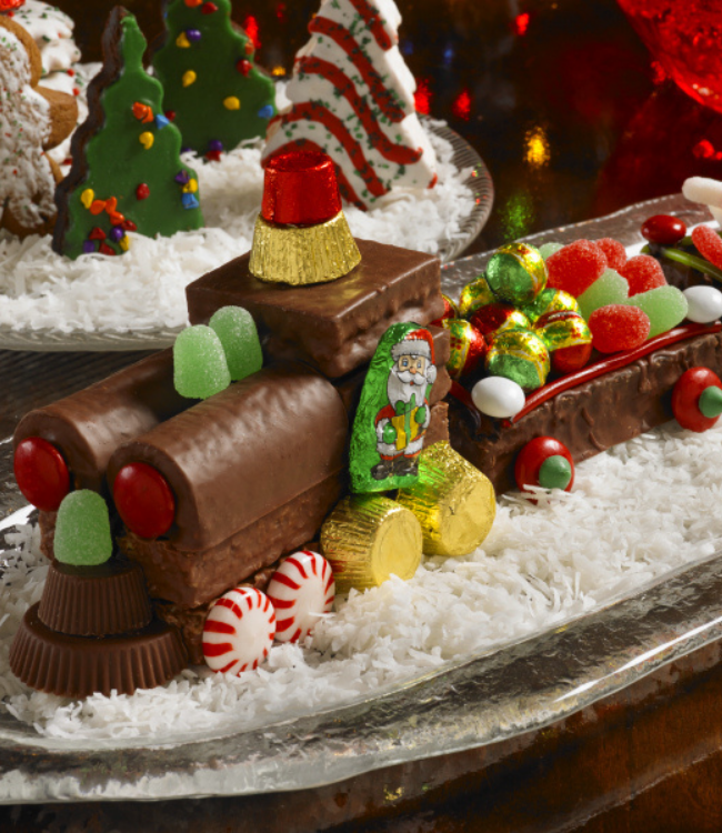 christmas train decorated with swiss rolls and frosted fudge cakes
