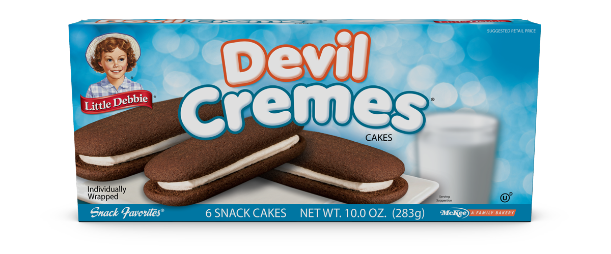 A box of devil cremes cookies with a glass of milk in the background.