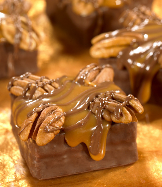 devil squares cake topped with walnuts, caramel and chocolate