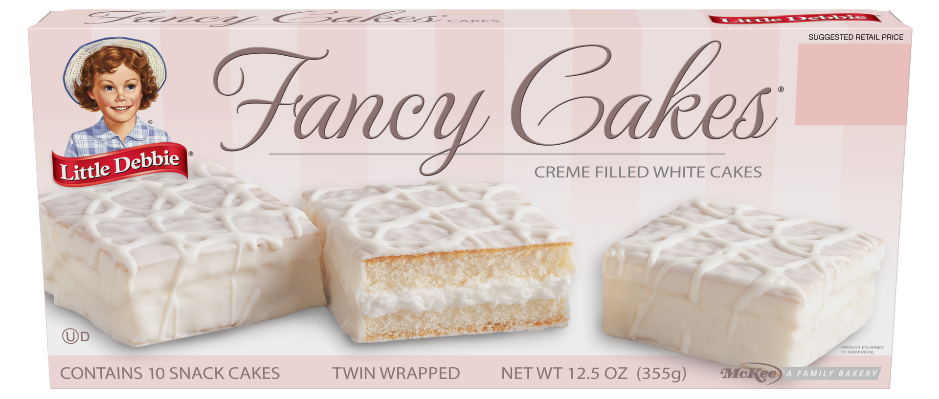 A box of fancy cakes is sitting on a table.