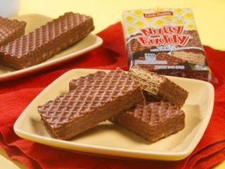 A stack of chocolate wafers on a white plate