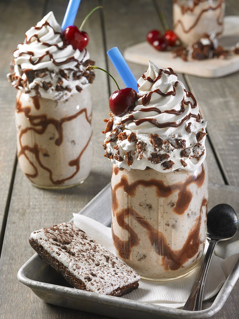 cosmic brownies on top of a milkshake with sprinkles and whipped cream topping