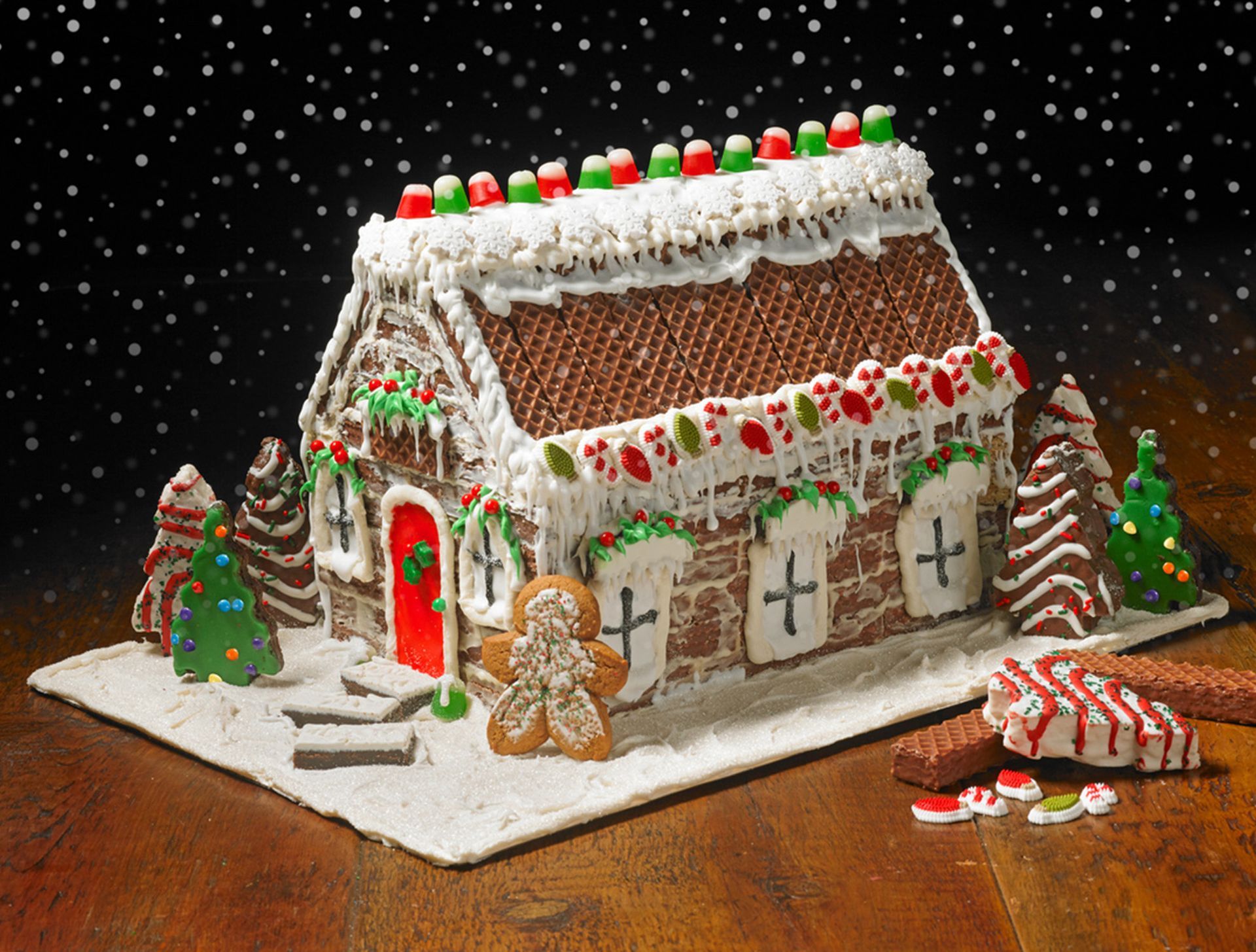 A gingerbread house with a gingerbread man in front of it