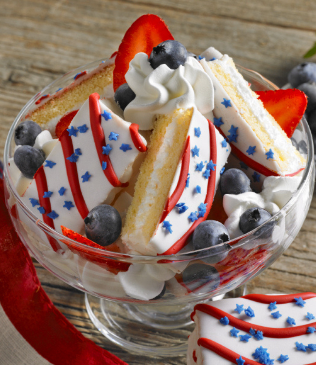 red white and blue cakes layered with whipped topping and fruit