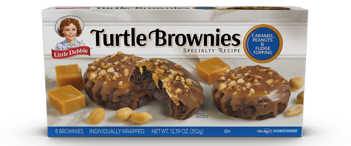 a box of turtle brownies with caramel peanuts and fudge topping