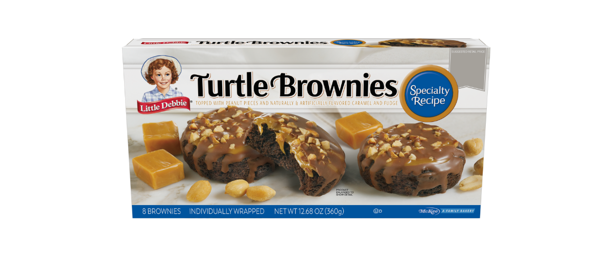 a box of turtle brownies with caramel peanuts and fudge topping