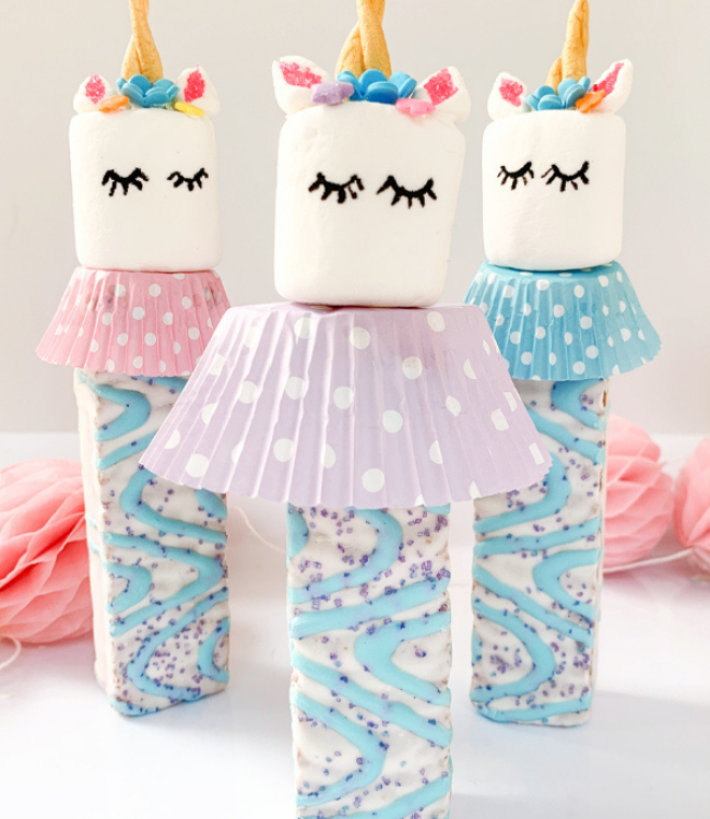 unicorn cakes topped with marshmallows and unicorn cake decor