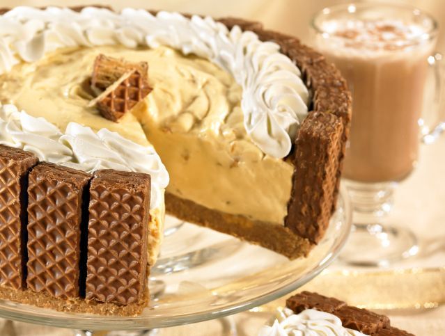 A pie with a slice taken out of it is on a glass plate.