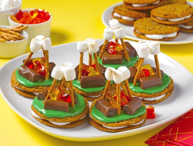 A white plate topped with s'mores made out of cookies and marshmallows