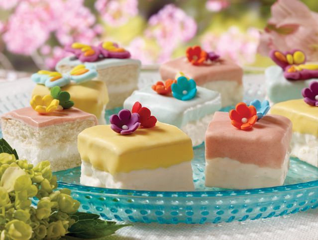 A plate of cakes with flowers on top of them