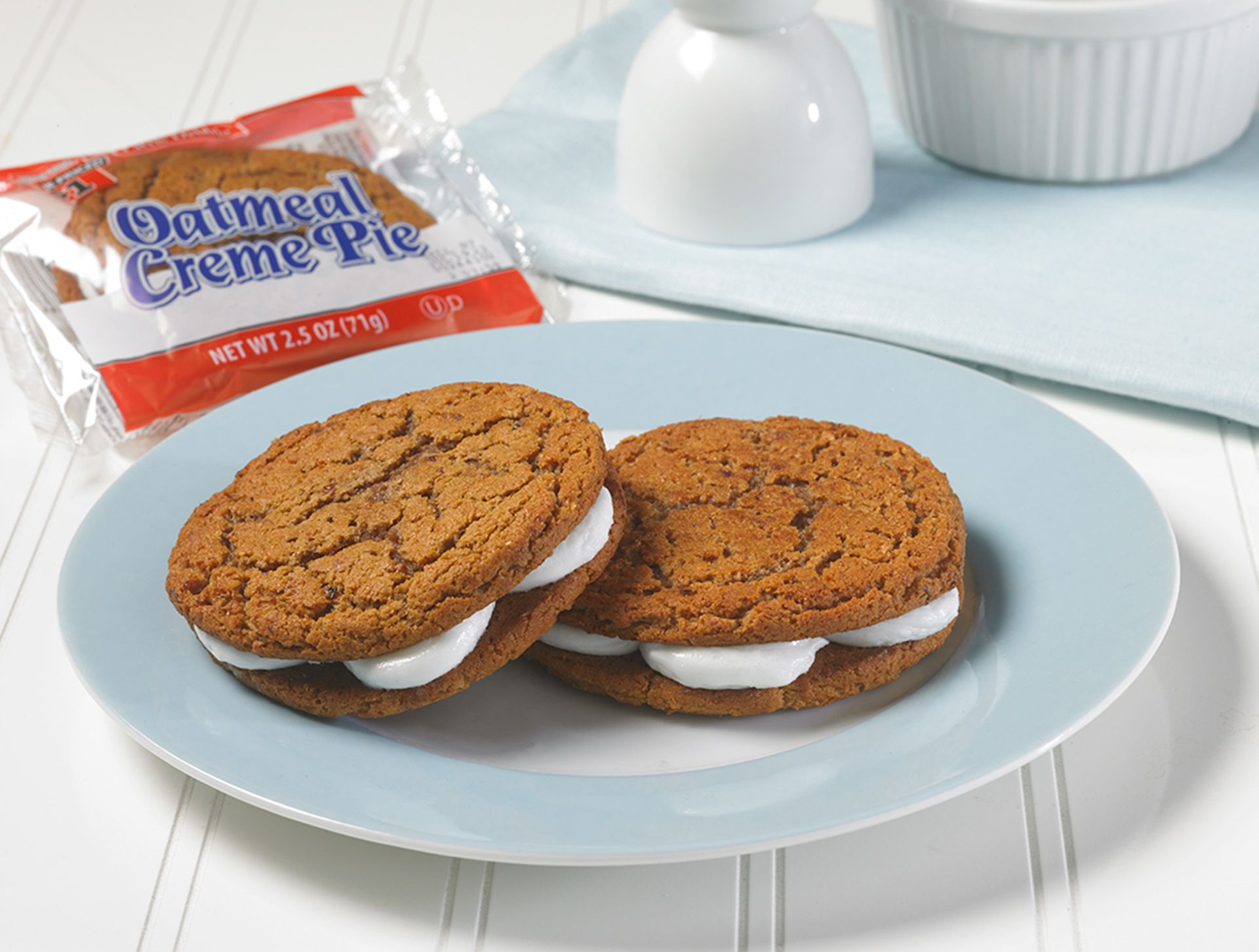 Two oatmeal creme pies are on a blue plate