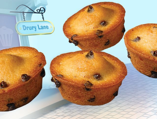 Four muffins on a table with a sign that says drury lane