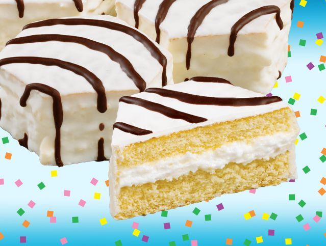 A slice of cake with white frosting and chocolate stripes