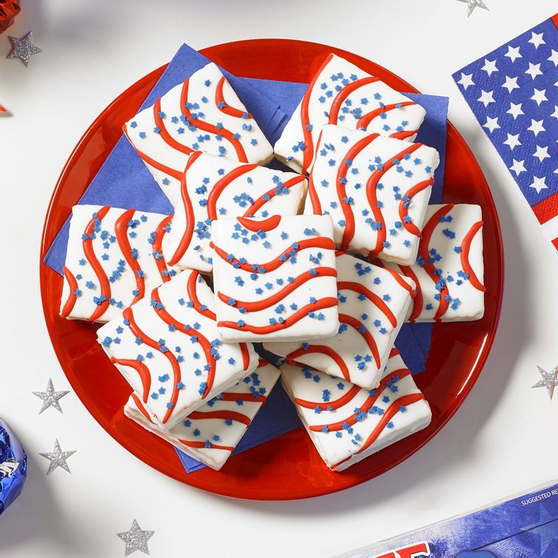 red plate topped with white iced and red striped cakes in a circle for red, white and blue