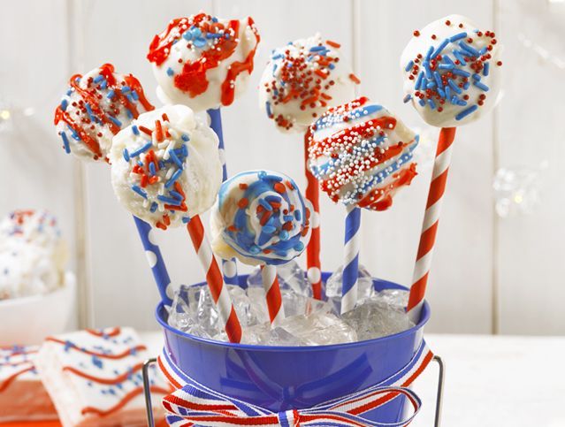 red white and blue cakes decorated as cake pops with festive decorations on paper straws