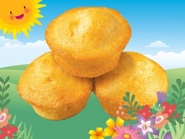 Three muffins are stacked on top of each other with flowers in the background