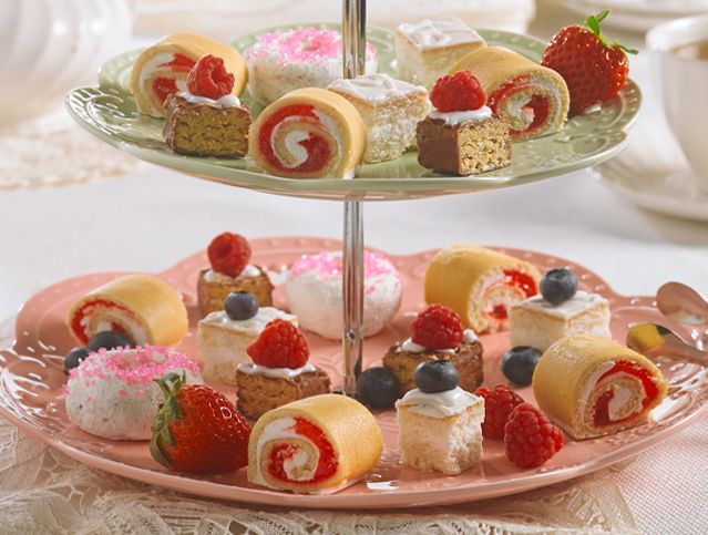 assorted little debbie cakes cut into petite servings and placed on a tea party tiered platter