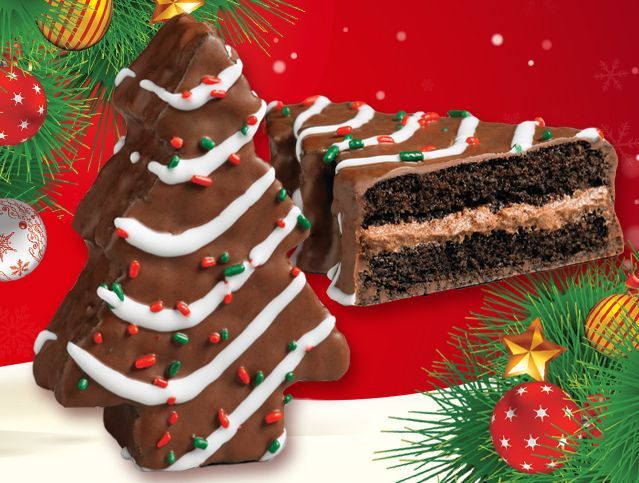 A choc christmas tree shaped cookie next to a slice of cake