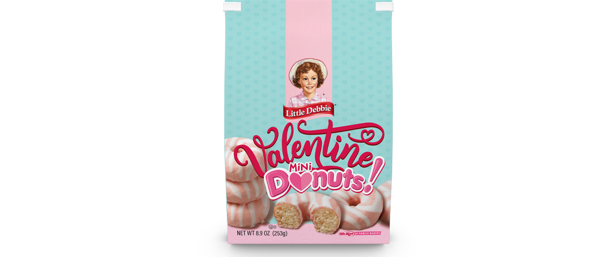 A bag of valentine 's day donuts with a picture of a woman on it.