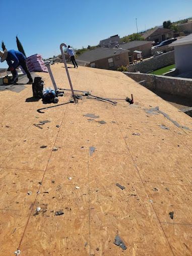 A man is working on the roof of a house.