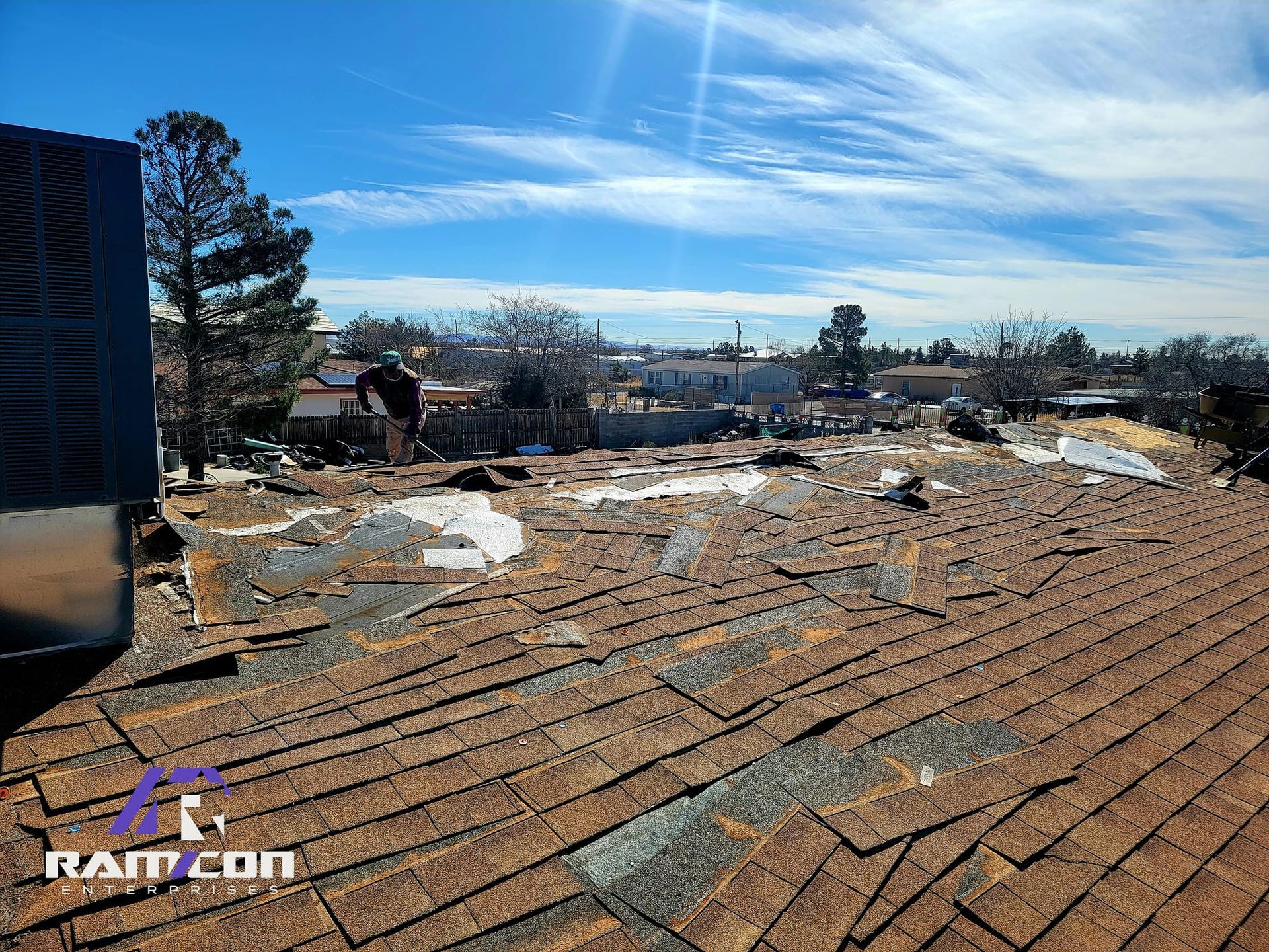 A roof is being repaired on a sunny day.
