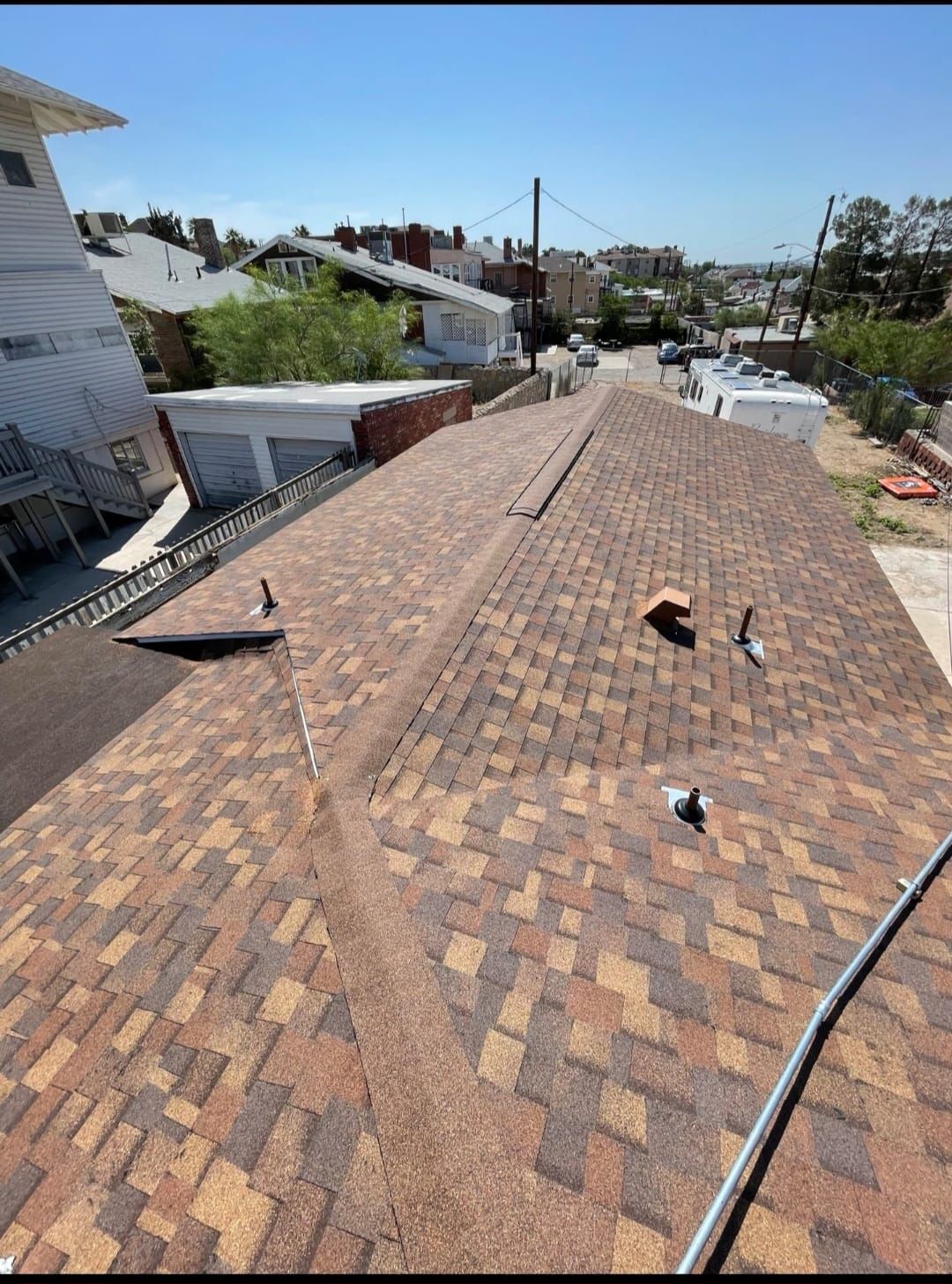 A roof with a lot of shingles on it is being repaired.
